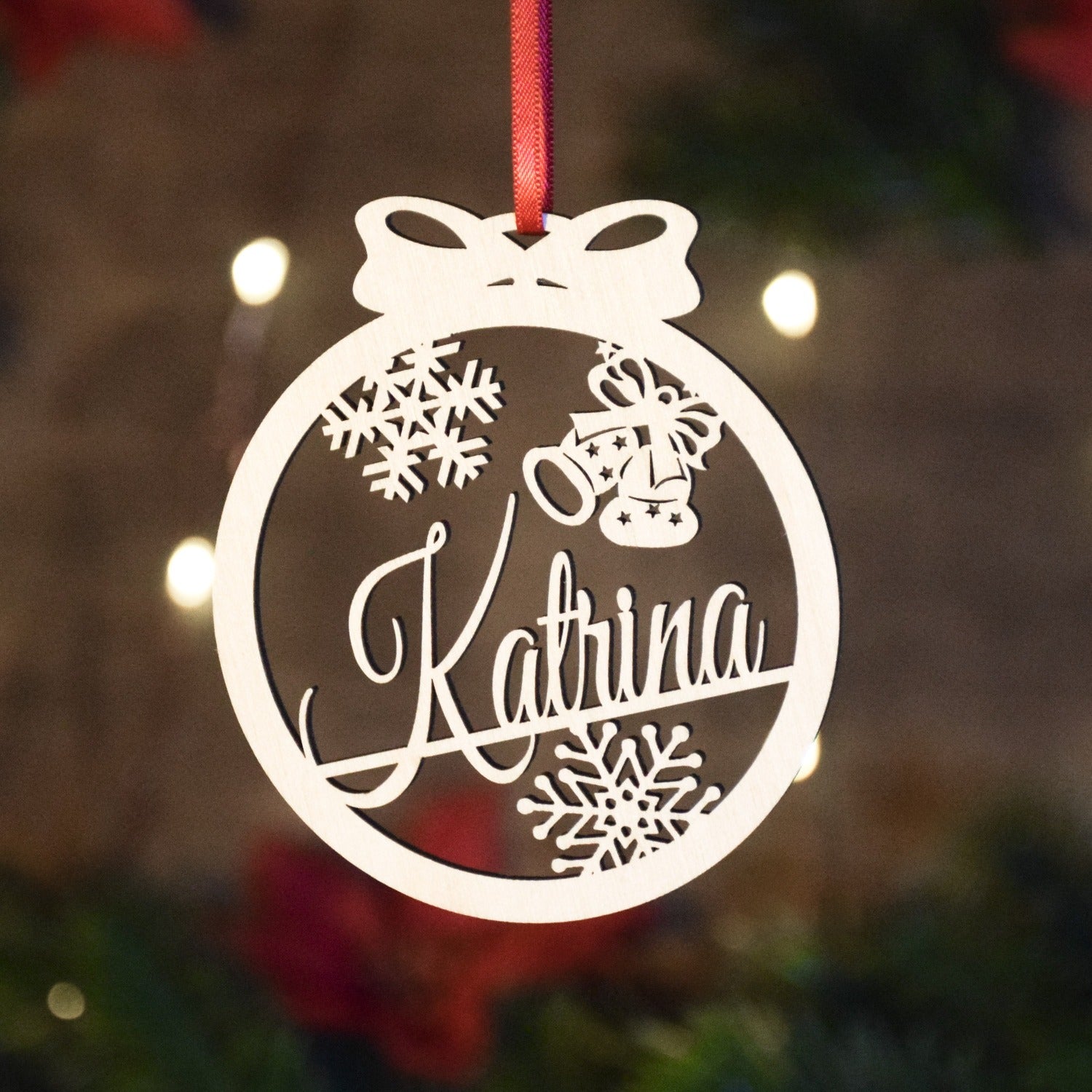Custom Christmas ornaments made from Baltic birch and personalized with a custom name or date. Great gifts for children or grandchildren. Bell shapes are cut into the top of the round shaped ornament.