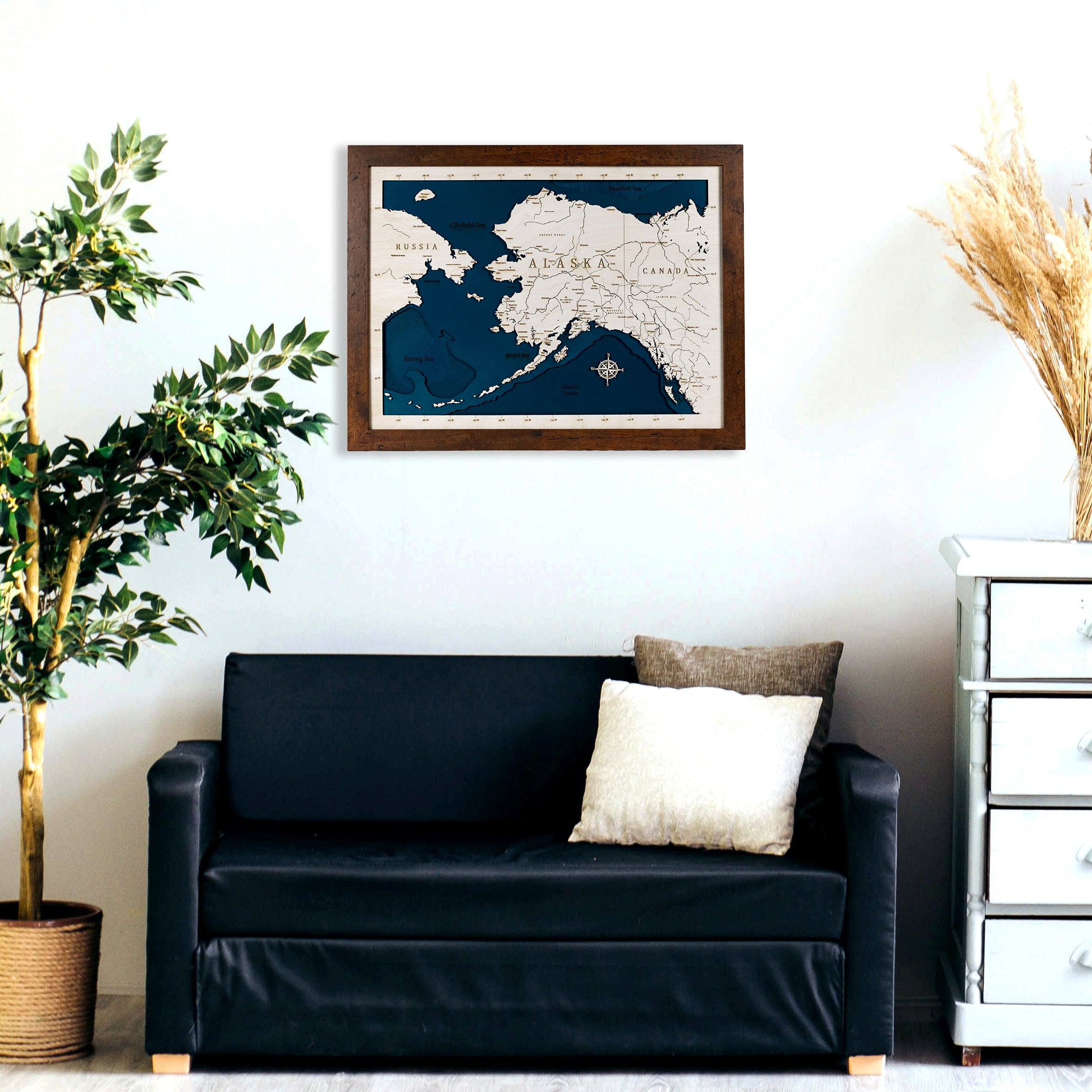 State of Alaska wood map on a wall over a couch. Excellent living room decor.