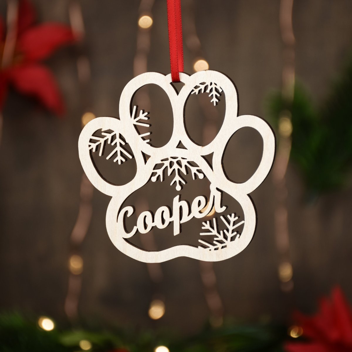 Custom paw shaped Christmas ornament made from Baltic birch and personalized with a custom name or date. The perfect gift for a dog or cat owner.