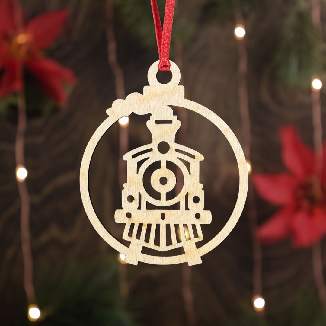 Decorative train ornament on a red string against a festive background with lights and poinsettias.
