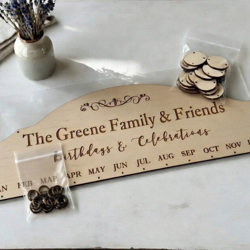 Wooden board with engraved text and small round items on a white surface