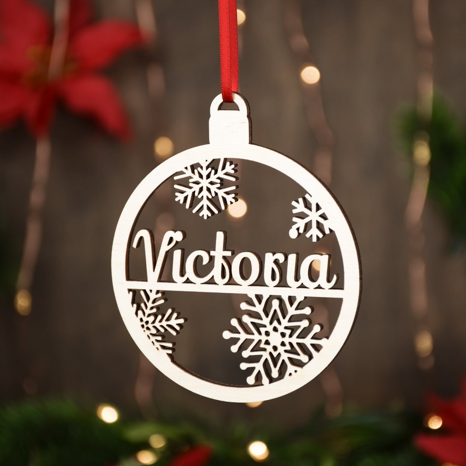 Alaskan Made Baltic Birch Christmas Ornament in a round shape with snowflakes.